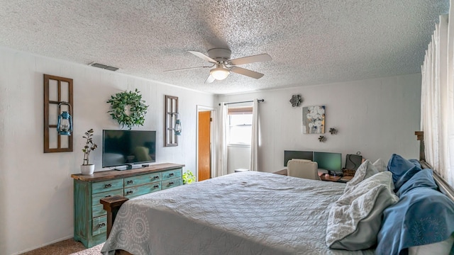 bedroom featuring carpet, a textured ceiling, and ceiling fan