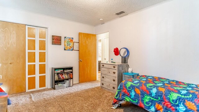 carpeted bedroom featuring a closet and a textured ceiling