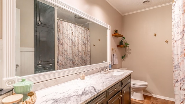 bathroom featuring ornamental molding, vanity, a textured ceiling, hardwood / wood-style floors, and toilet