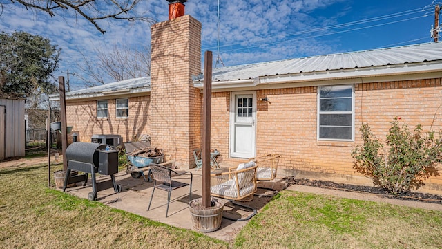 back of house with a lawn and a patio area