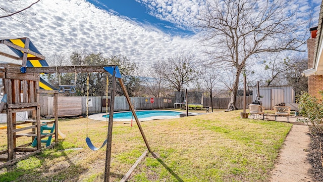 view of yard featuring a trampoline, a playground, a shed, a fenced in pool, and a patio area