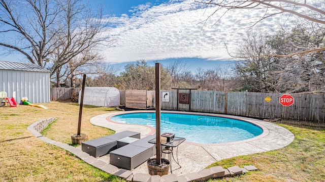 view of pool with a lawn