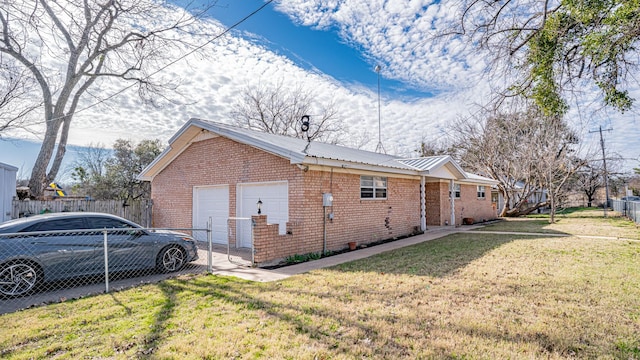 view of side of home with a lawn and a garage