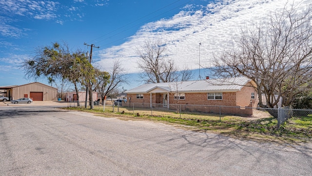 view of front of property with a garage and an outdoor structure