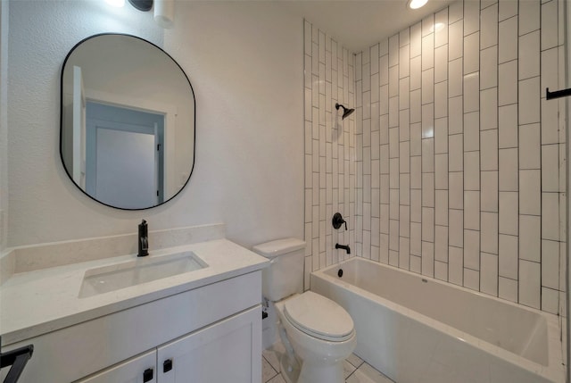 full bathroom featuring vanity, tile patterned flooring, toilet, and tiled shower / bath