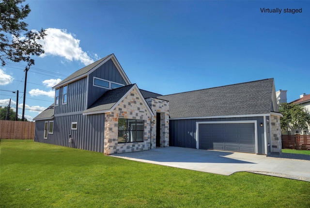 view of front of property with a garage and a front lawn