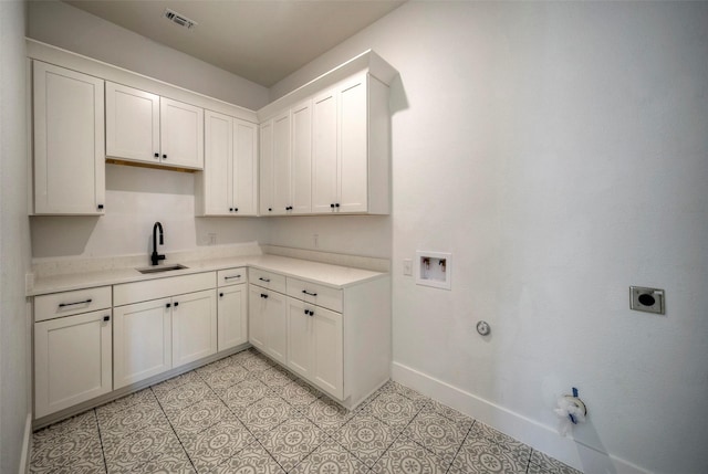 laundry area featuring gas dryer hookup, sink, light tile patterned floors, electric dryer hookup, and washer hookup