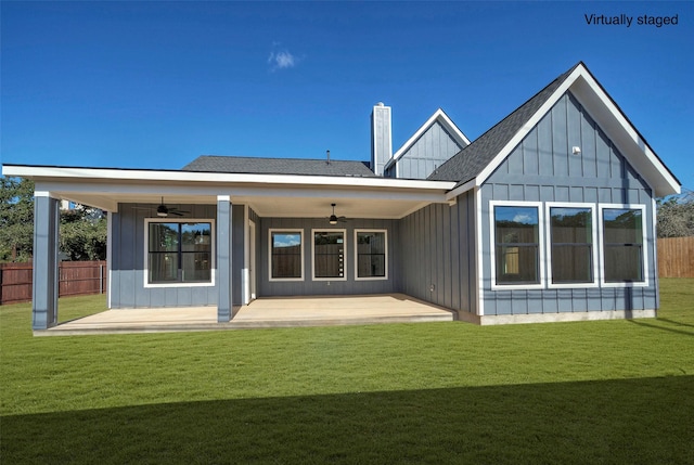 back of property with ceiling fan, a patio, and a lawn