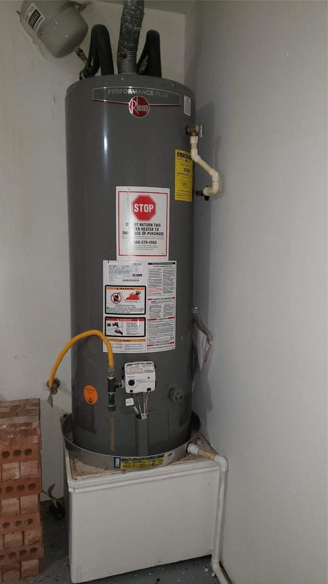 utility room featuring gas water heater