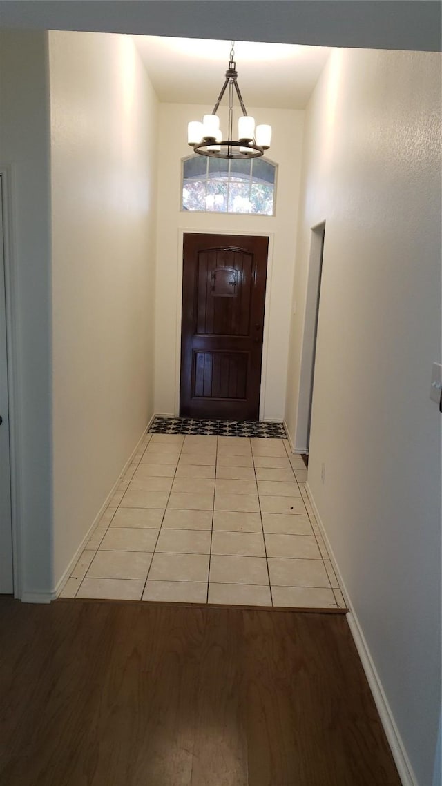 entryway featuring light hardwood / wood-style floors and an inviting chandelier