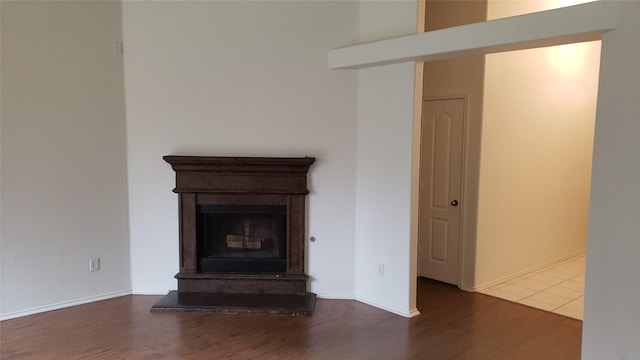 unfurnished living room with dark hardwood / wood-style floors