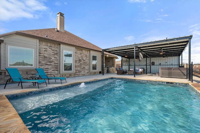 view of pool featuring a patio area and a hot tub