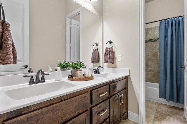 full bath featuring a sink, double vanity, shower / bath combination with curtain, and tile patterned floors