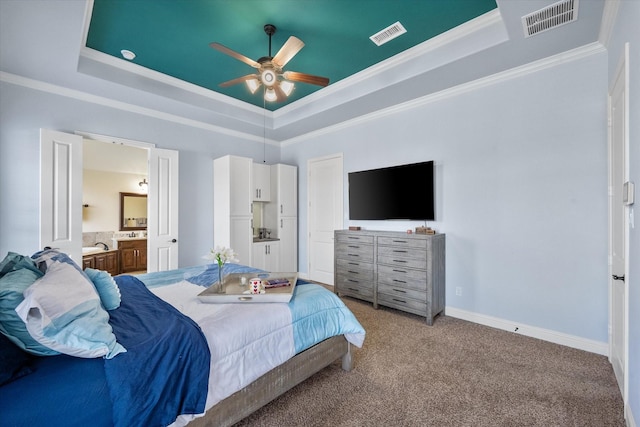 bedroom featuring visible vents, a raised ceiling, crown molding, and light colored carpet