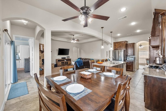 dining room with arched walkways, light tile patterned floors, recessed lighting, visible vents, and ceiling fan