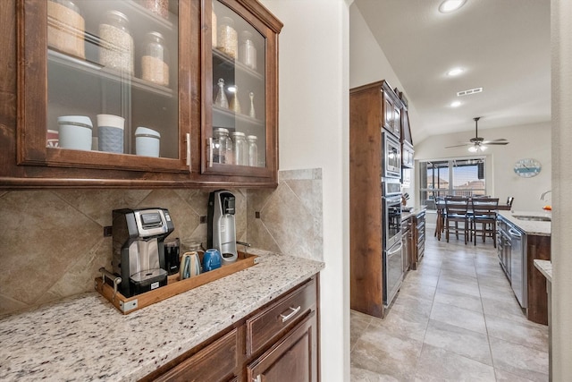 bar featuring tasteful backsplash, visible vents, a ceiling fan, appliances with stainless steel finishes, and a sink