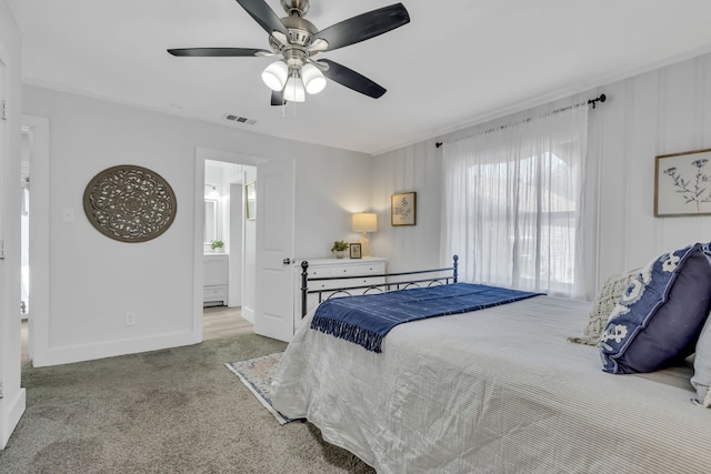 carpeted bedroom featuring ensuite bath and ceiling fan