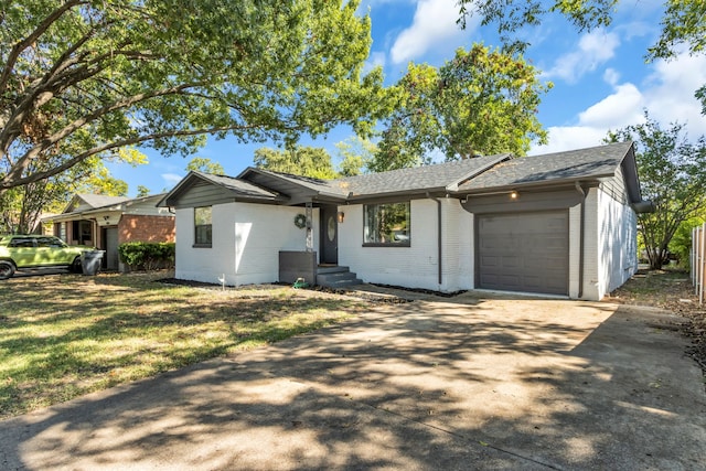 single story home with a front yard and a garage