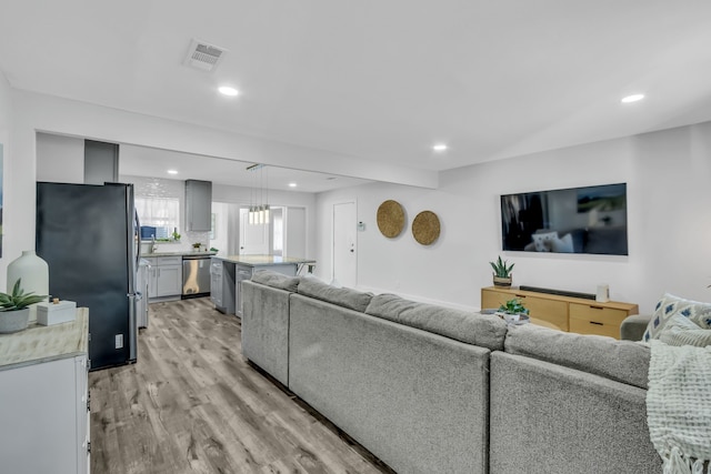 living room with light hardwood / wood-style flooring