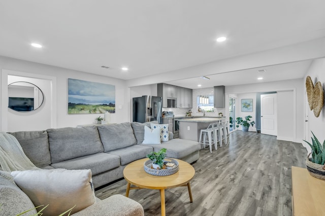 living room featuring light hardwood / wood-style floors and sink