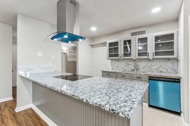 kitchen featuring dishwasher, light stone countertops, black electric cooktop, tasteful backsplash, and island exhaust hood