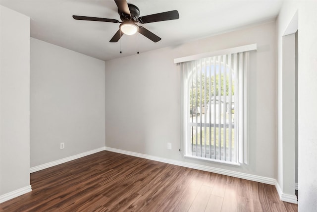 unfurnished room with ceiling fan and dark hardwood / wood-style flooring