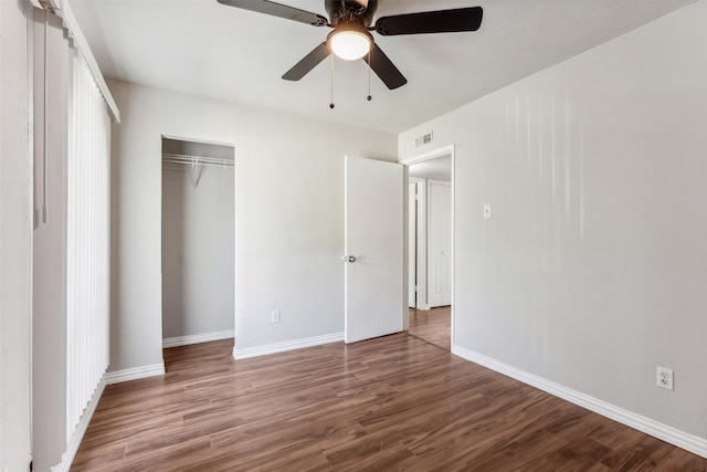 unfurnished bedroom featuring wood-type flooring, a closet, and ceiling fan