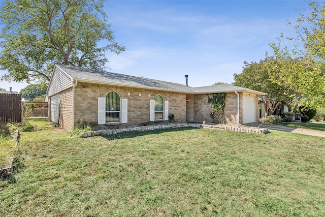 ranch-style home featuring a garage and a front lawn