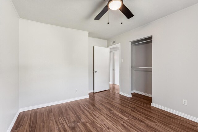 unfurnished bedroom featuring a closet, ceiling fan, and dark hardwood / wood-style floors