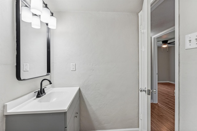 bathroom featuring hardwood / wood-style floors, vanity, and ceiling fan