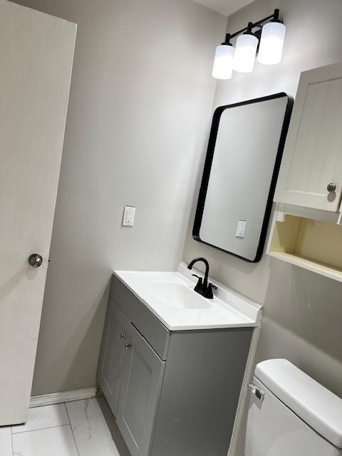 bathroom featuring vanity and toilet