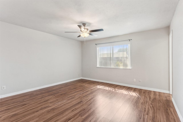 spare room featuring ceiling fan and dark hardwood / wood-style floors