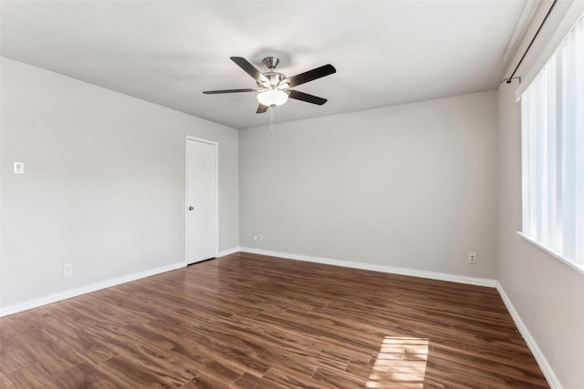 spare room featuring ceiling fan, dark hardwood / wood-style flooring, and plenty of natural light