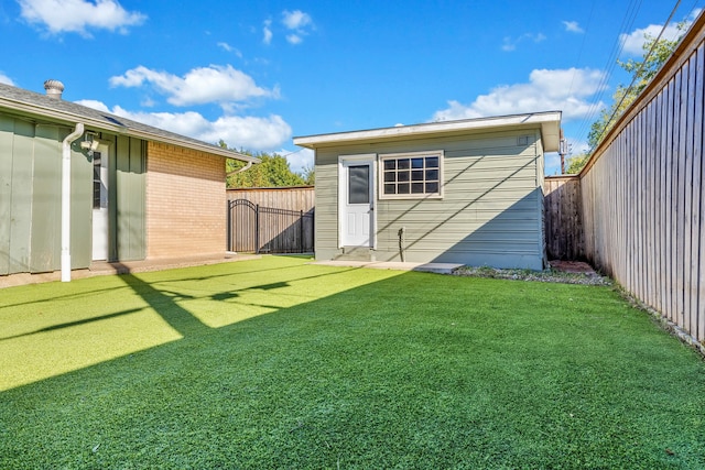 view of outbuilding featuring a lawn