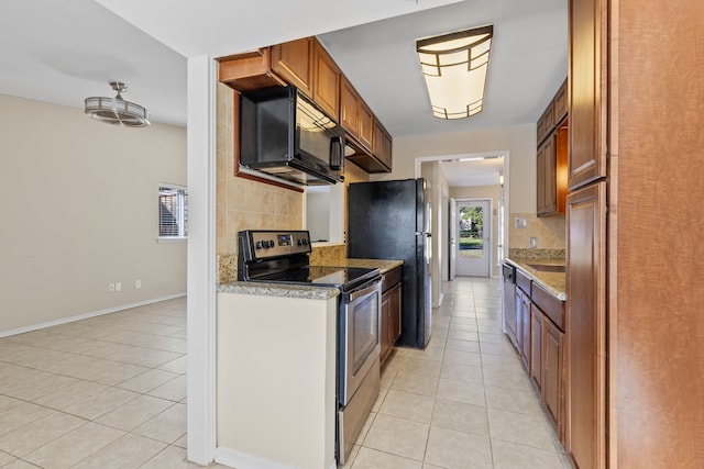 kitchen with black appliances, decorative backsplash, and light tile patterned flooring