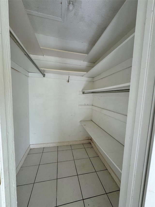 walk in closet featuring light tile patterned floors