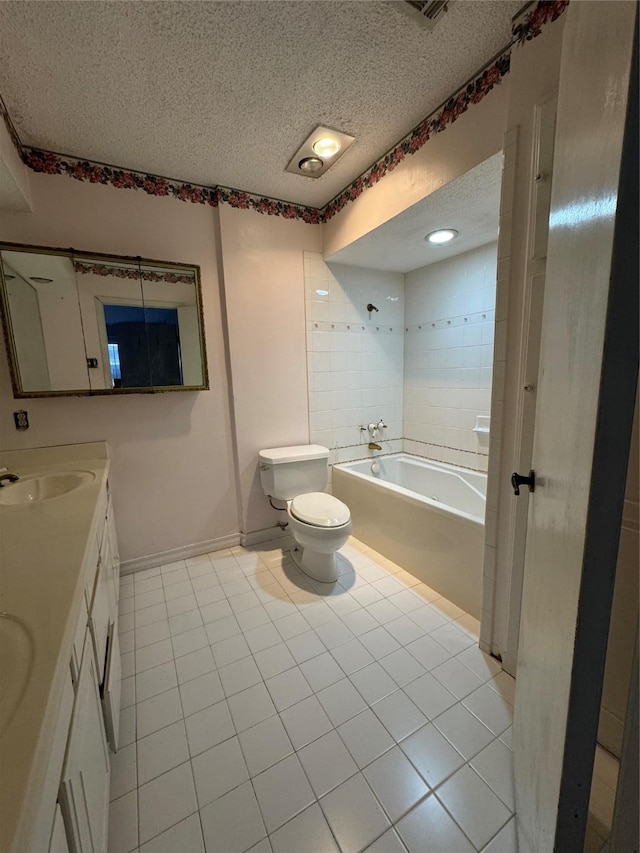 full bathroom with tile patterned floors, vanity, a textured ceiling, washtub / shower combination, and toilet