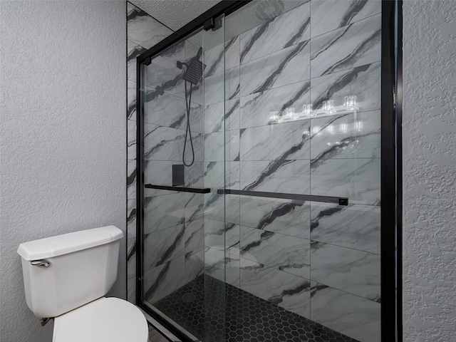 bathroom with toilet and an enclosed shower