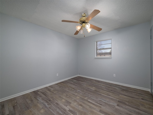 empty room featuring a textured ceiling, dark hardwood / wood-style floors, and ceiling fan