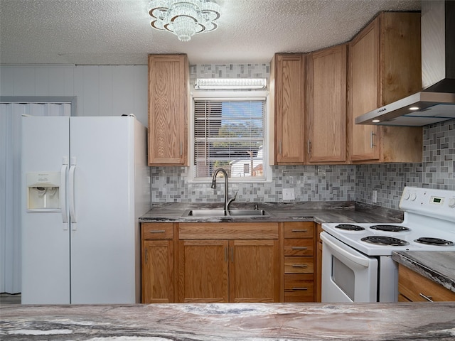 kitchen featuring sink, white appliances, wall chimney exhaust hood, and a textured ceiling