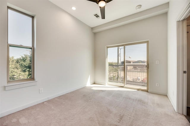 unfurnished room featuring light carpet and ceiling fan