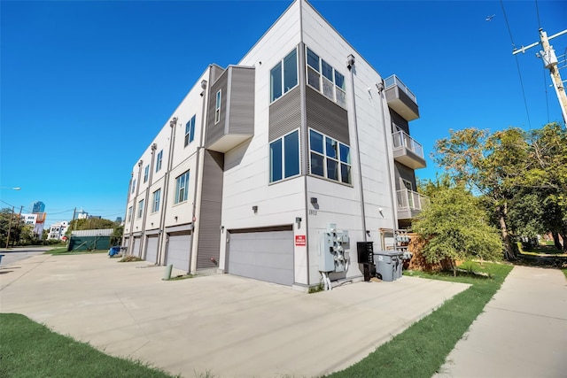 view of home's exterior featuring a garage and a balcony