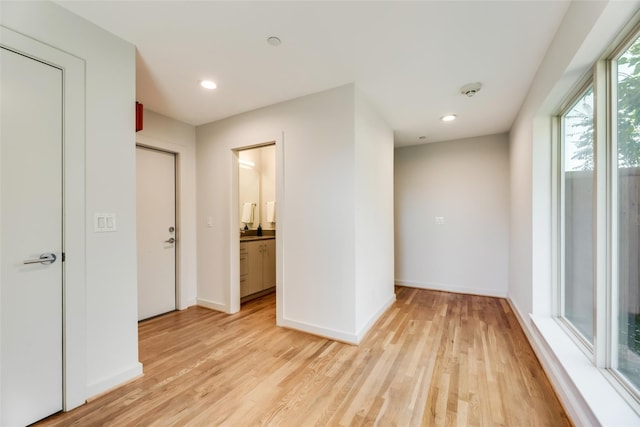 interior space with light hardwood / wood-style floors and ensuite bath