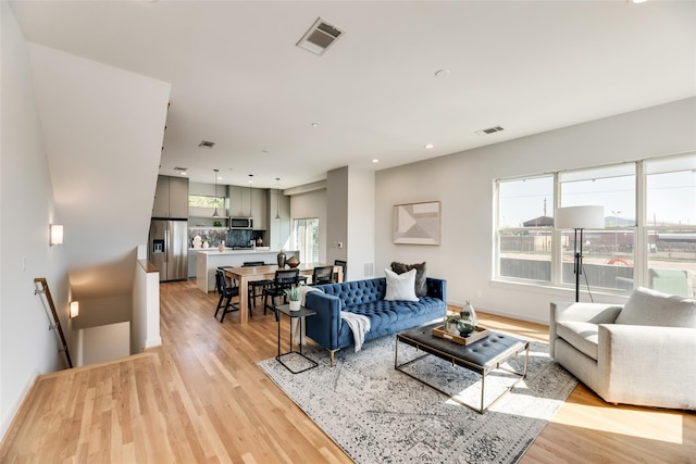 living room with light hardwood / wood-style flooring