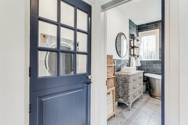 bathroom featuring vanity and tile walls