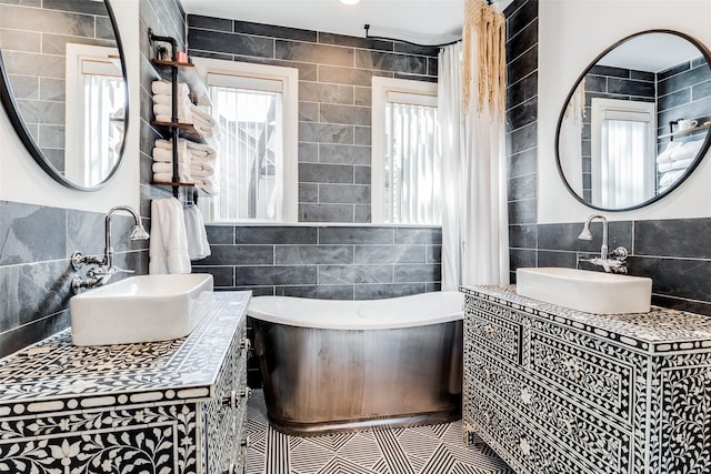 bathroom featuring vanity, a tub to relax in, and tile walls