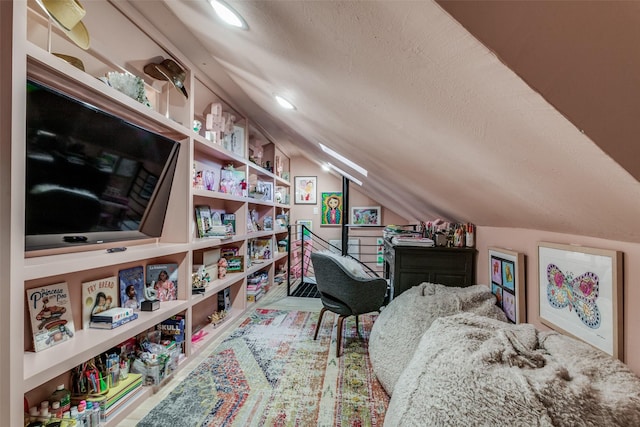 game room with lofted ceiling and a textured ceiling