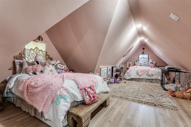 bedroom featuring light hardwood / wood-style floors and vaulted ceiling