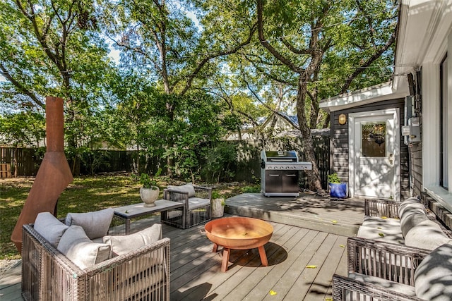 deck featuring an outdoor living space and a grill