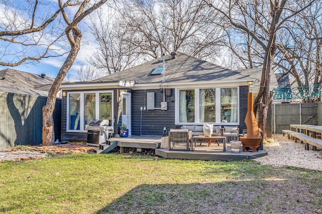 rear view of house with a lawn, an outdoor living space, and a wooden deck